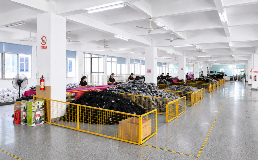 Quality control staff inspecting backpacks, checking stitching, zippers, and hardware in a clean factory environment