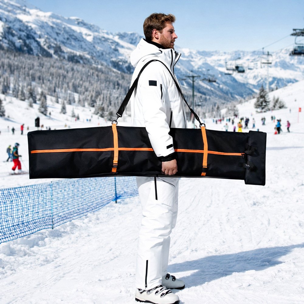 Skier carrying Nice Bags adjustable snowboard bag horizontally at snowy ski resort