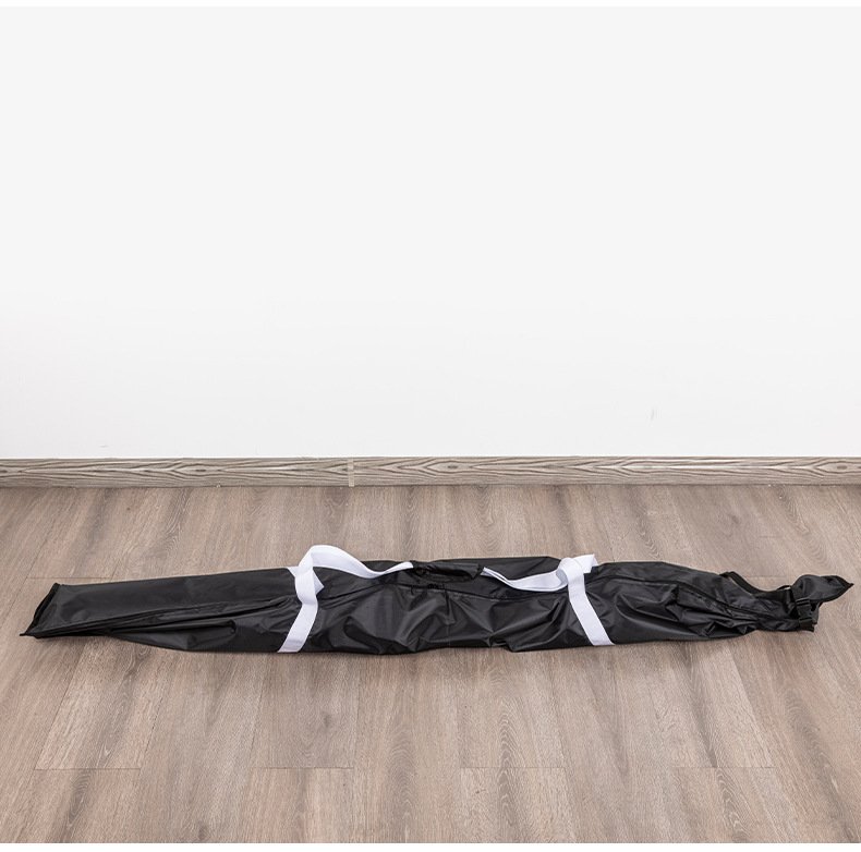 Full length top view of Nice Bags black ski bag with white carrying webbing on wooden floor