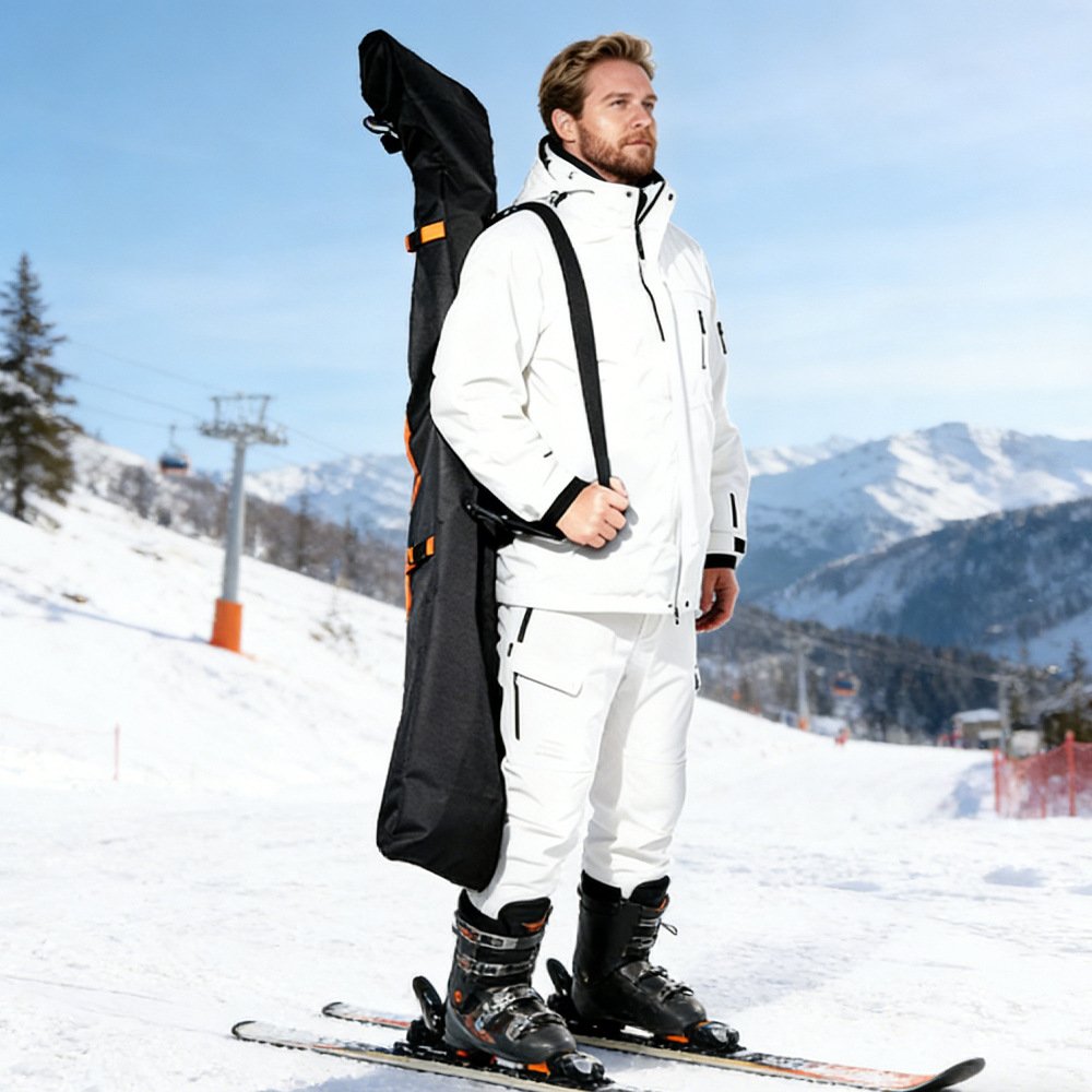 Skier carrying Nice Bags black snowboard bag vertically on back at ski slopes