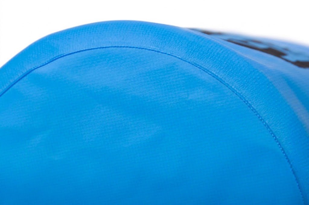 Close-up of a precision-stitched seam on the base of a custom dry bag, showing tight, evenly spaced stitching along the fabric edge