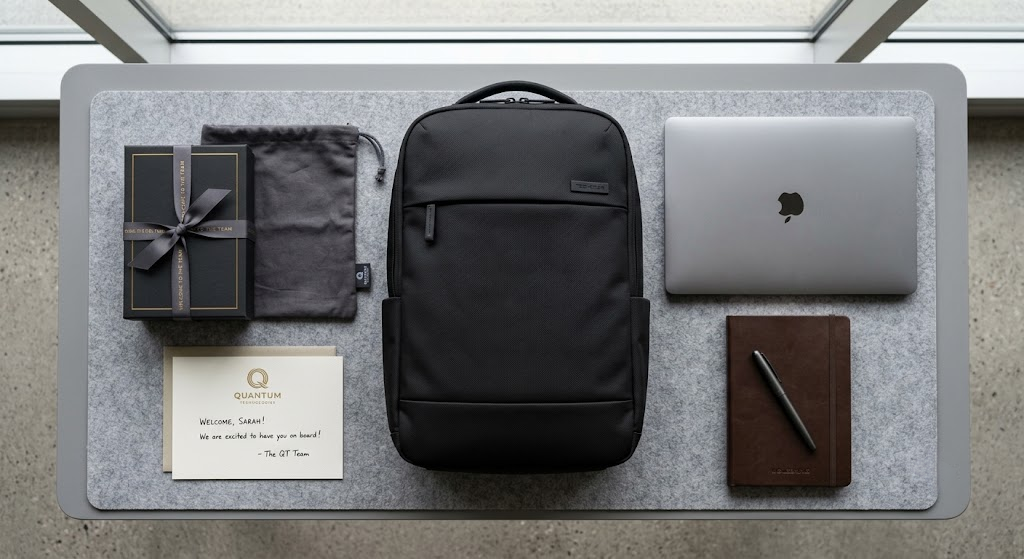 Custom corporate onboarding gift set with black laptop corporate backpack, branded packaging, and welcome card