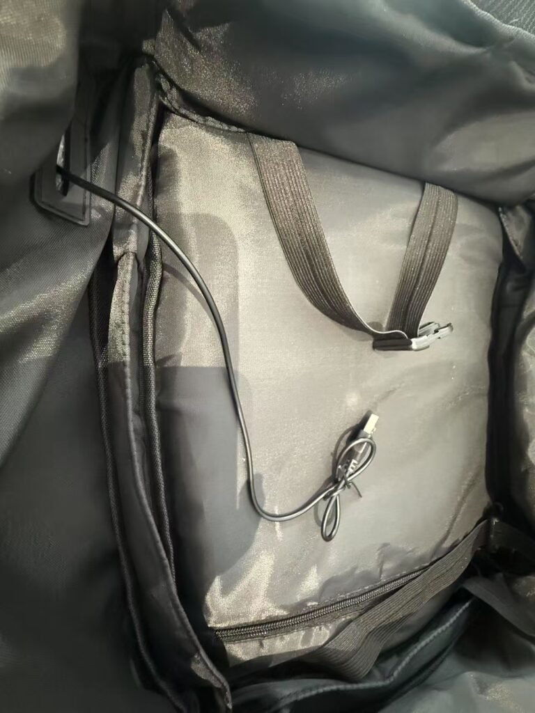 Interior USB charging cable and port inside business travel backpack