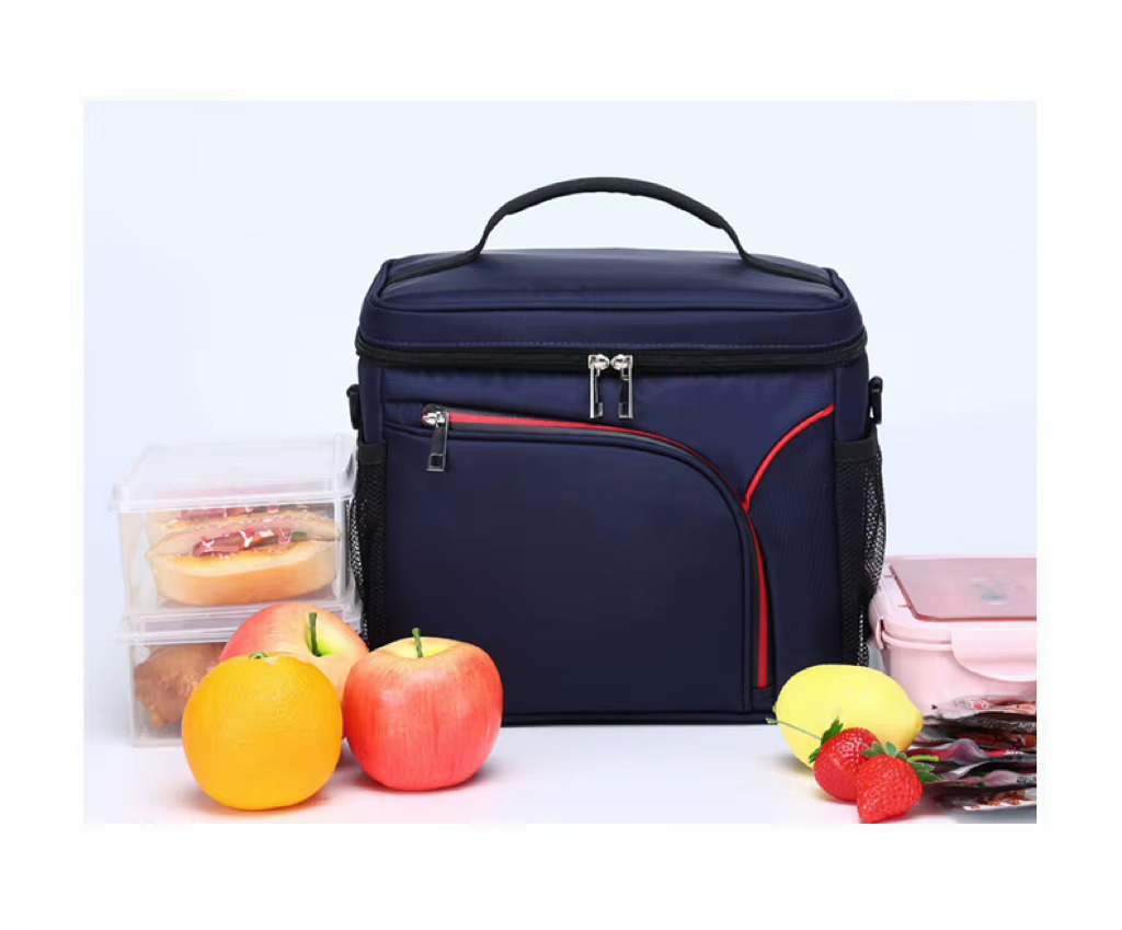 bag on table with lunch boxes and fresh fruit