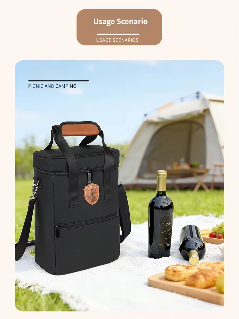 black bag on picnic blanket beside wine bottles and cheese board