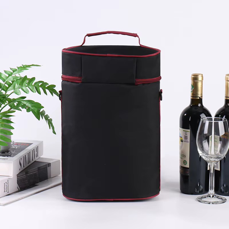 black red-piped bag back view beside wine bottles and glass