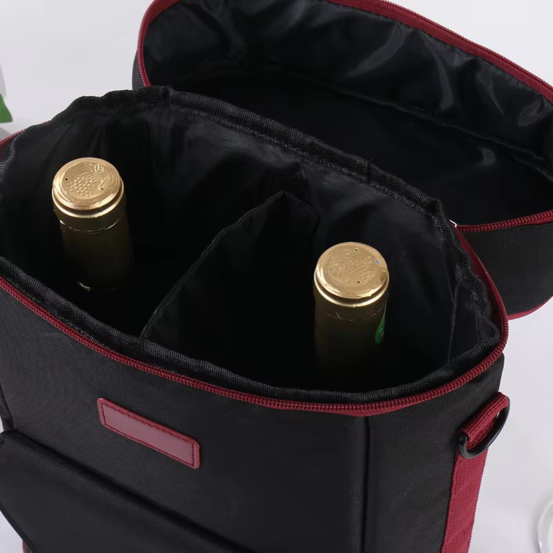 open black red-piped bag showing two bottles in divided interior