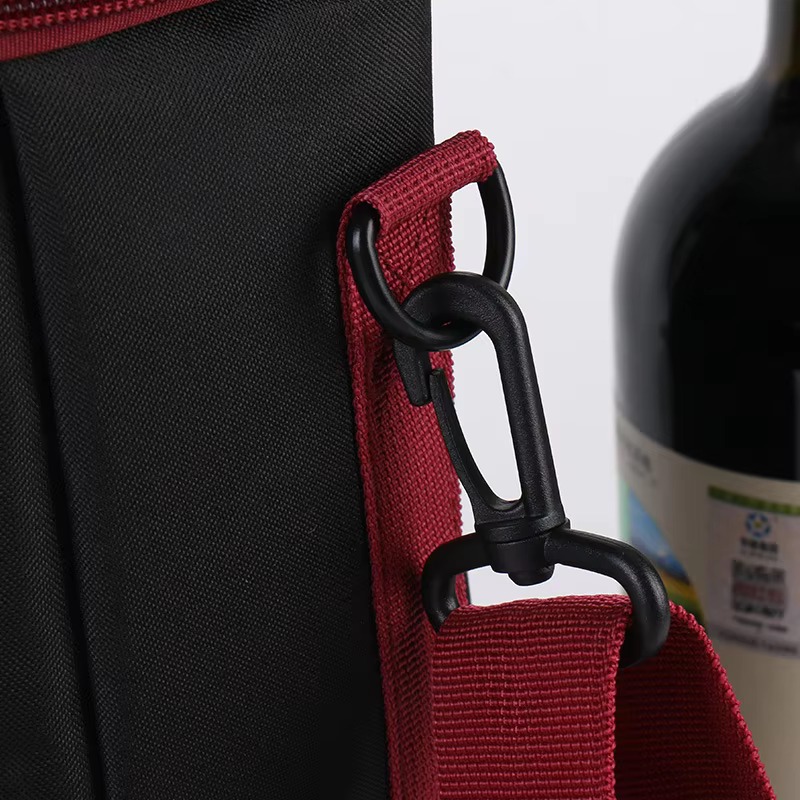 close-up of red webbing strap and black plastic snap hook