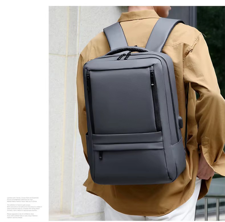 man wearing gray backpack outdoors