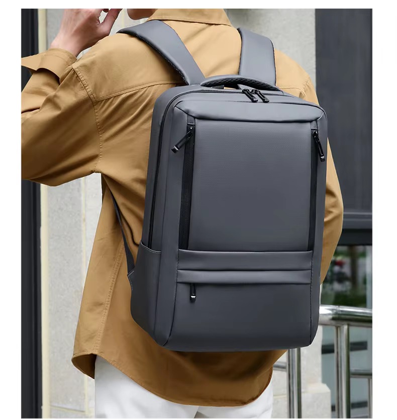 man wearing gray backpack close-up on shoulder