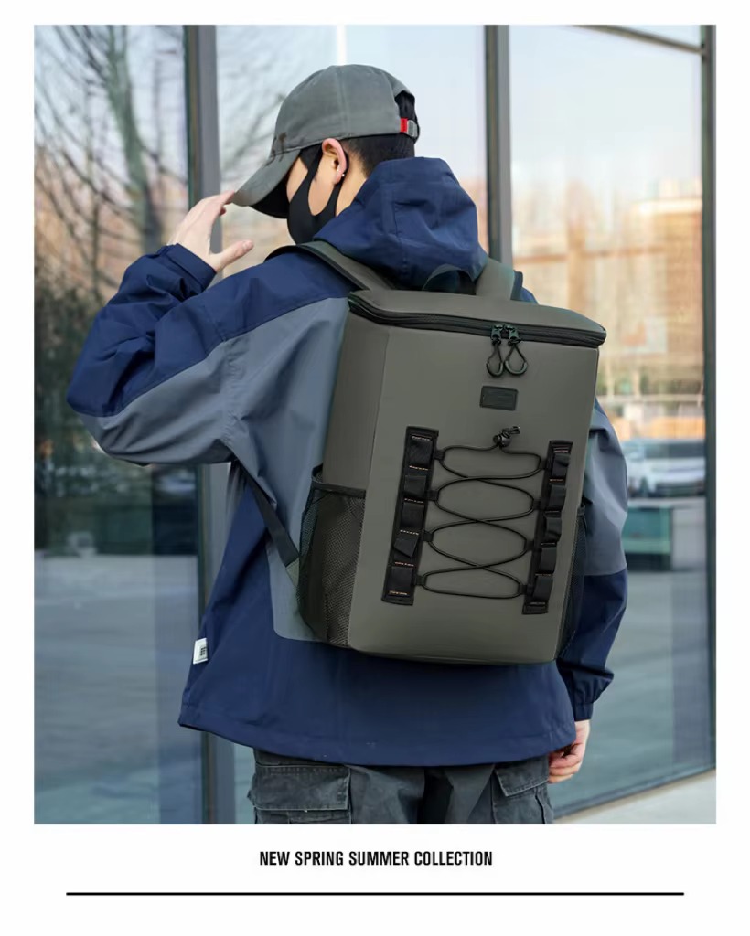 man carrying olive green cooler backpack by top handle on the street