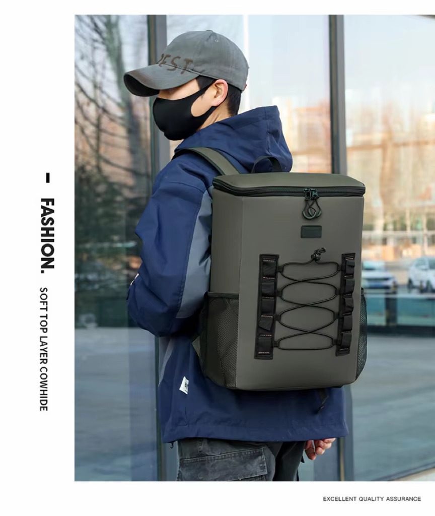 man wearing olive green cooler backpack outdoors near glass building
