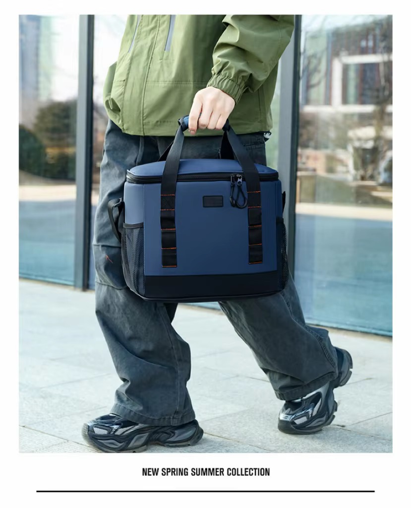 man walking while holding navy blue bag by top handle