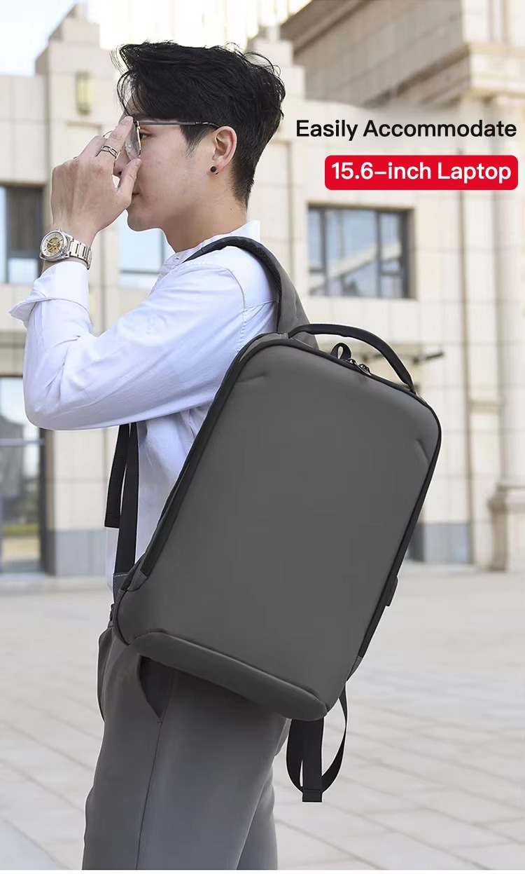 man checking his phone with backpack over one shoulder, fits 15.6-inch laptop