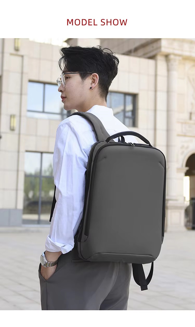model wearing gray backpack over one shoulder outdoors