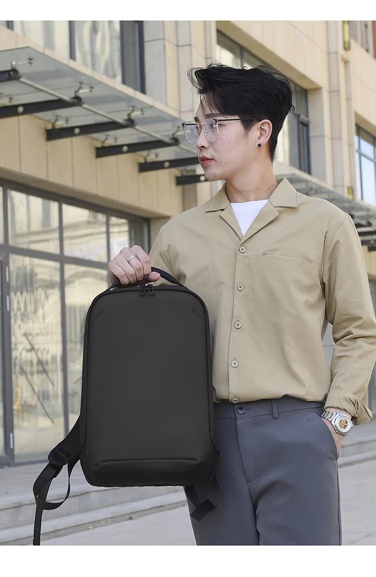 close-up of zipper, top handle, and shoulder strap buckle details