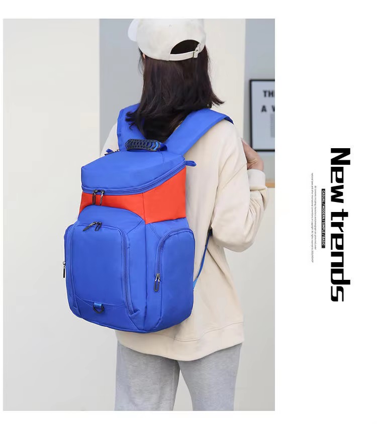 woman wearing the blue and orange backpack, rear view