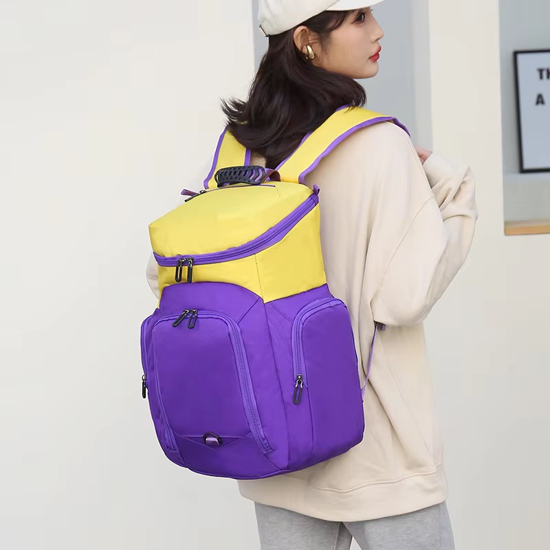 woman wearing the purple and yellow colorway backpack, rear view