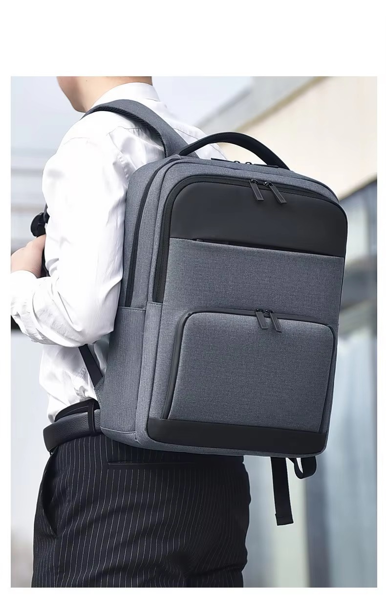 man wearing the gray colorway backpack with pinstripe trousers