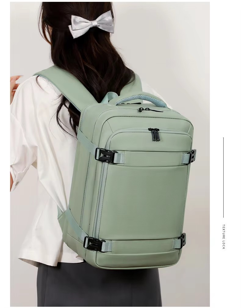 green backpack held by top handle close-up