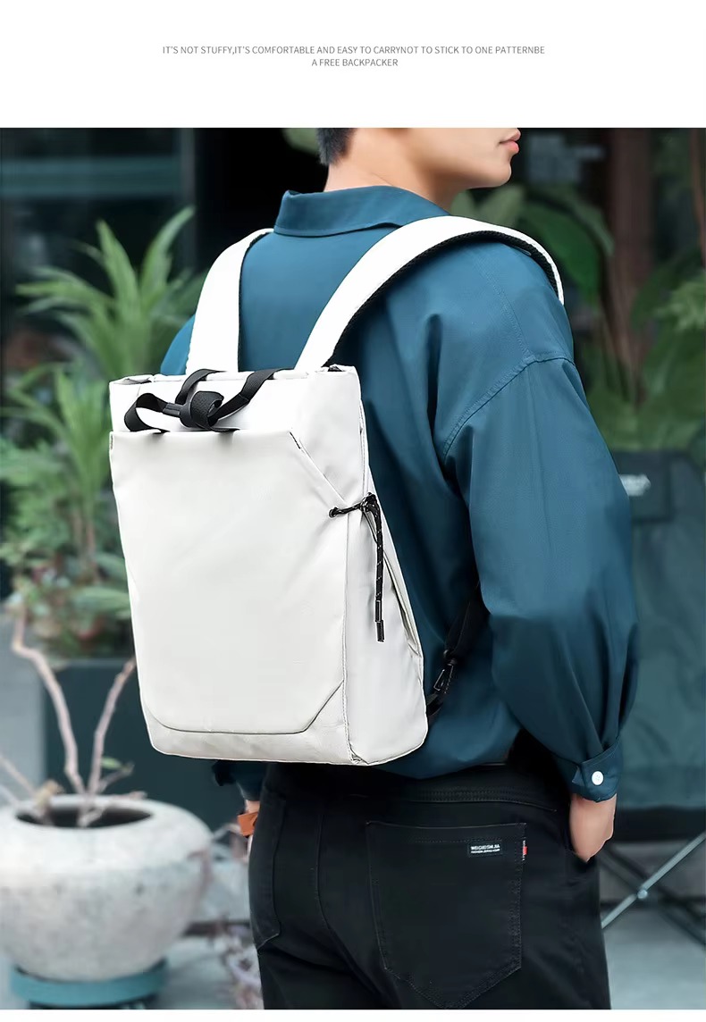 man wearing white backpack on single shoulder strap