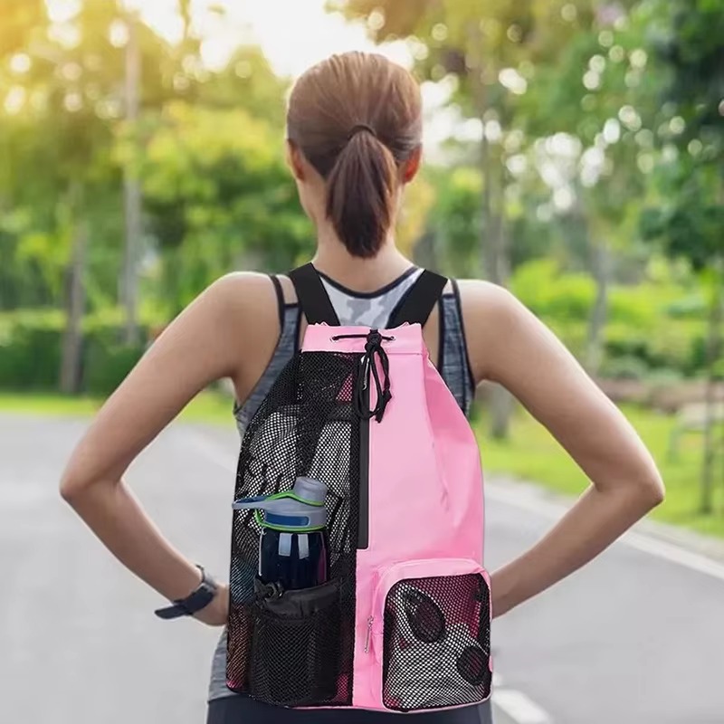 woman wearing pink mesh backpack outdoors on a running path
