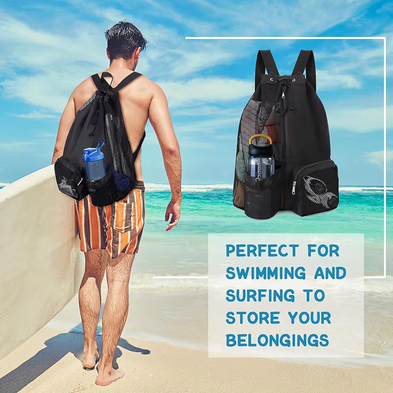 man carrying black backpack on beach with surfboard