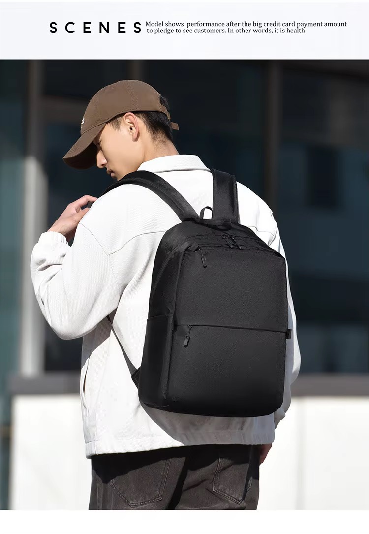 man wearing black backpack over shoulder walking outdoors