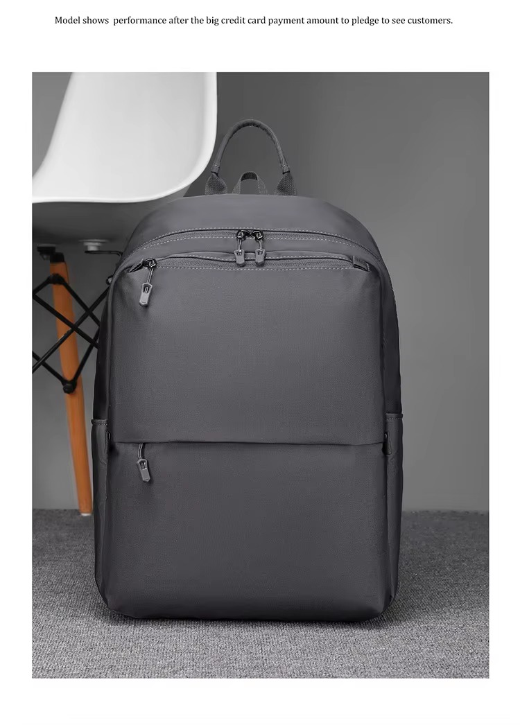 gray backpack front view beside a chair