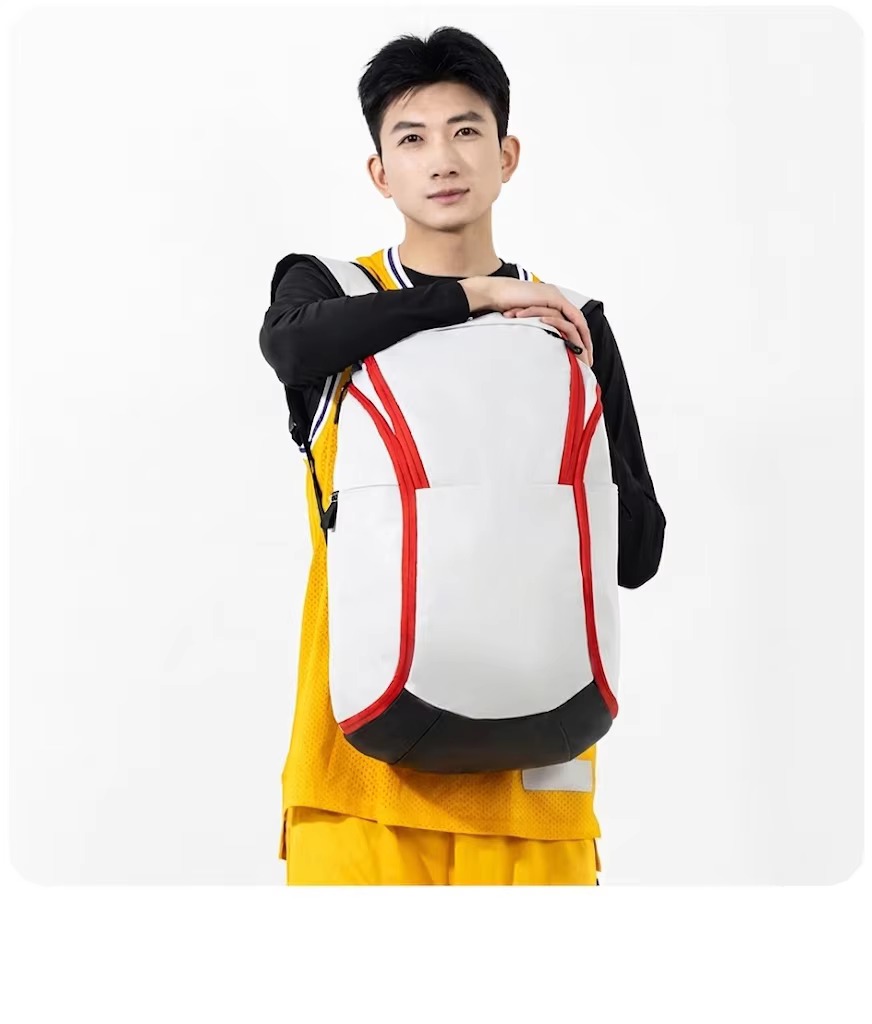 man holding white and red backpack