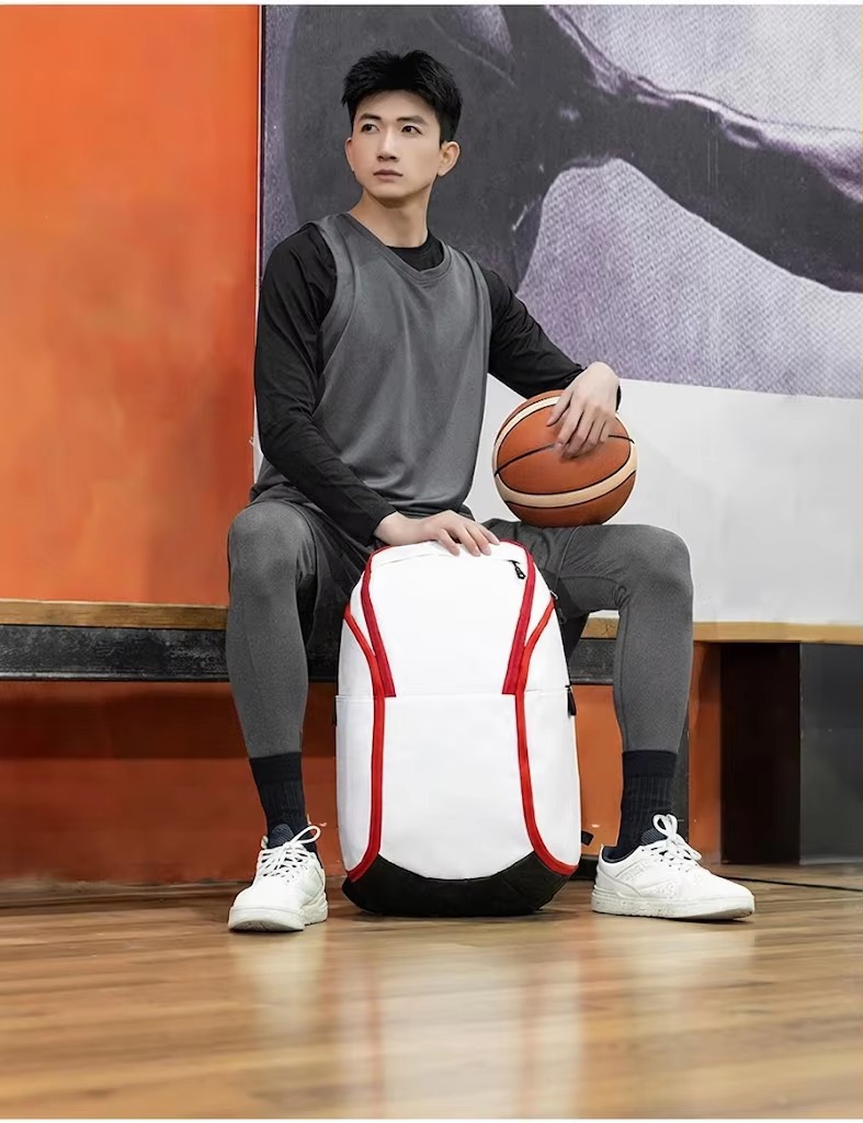 man seated next to white backpack on bench