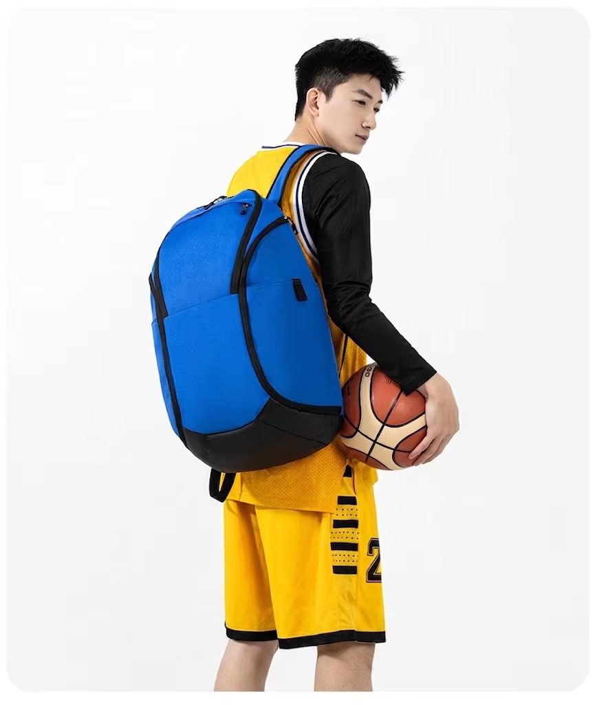 man wearing blue backpack holding basketball
