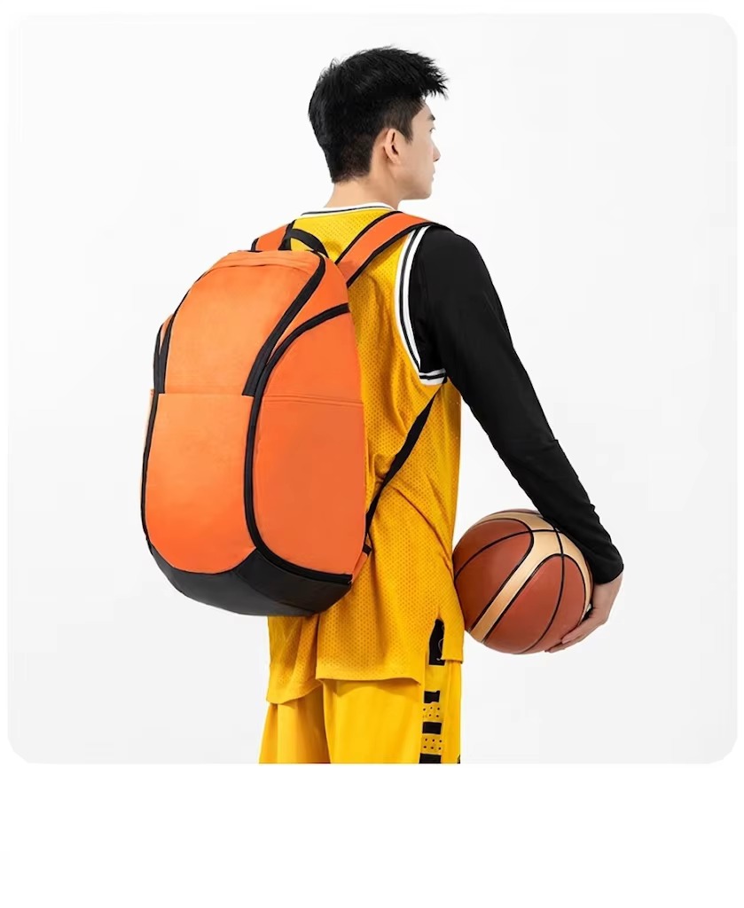 man wearing orange backpack shown from behind