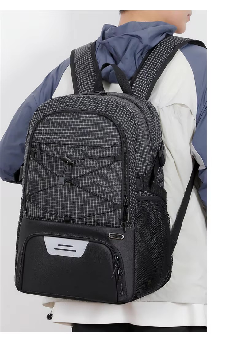 man seated beside the backpack and a gym bag