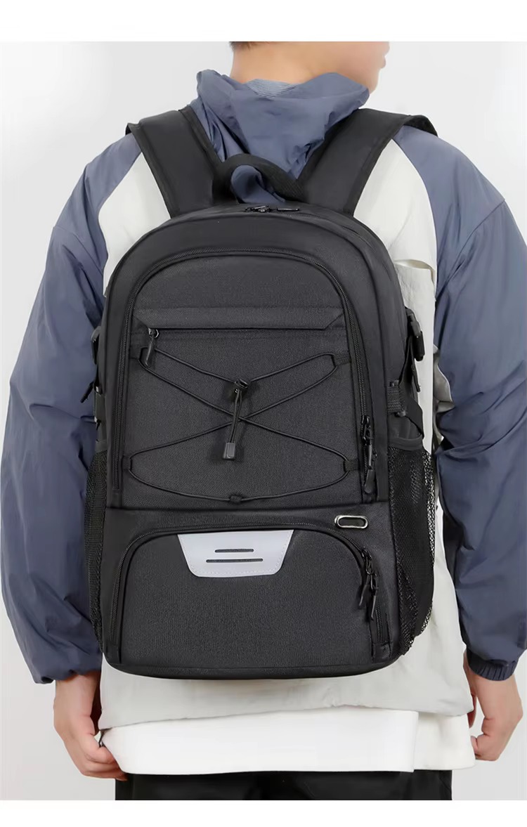 man holding the backpack by its top handle