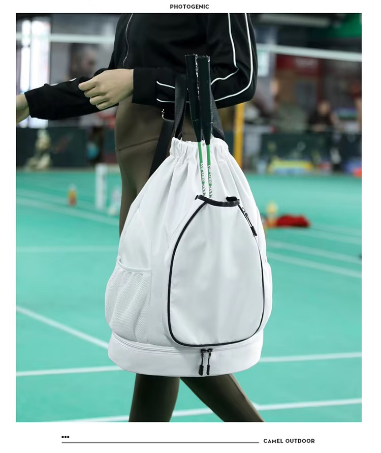 white backpack with rackets on badminton court