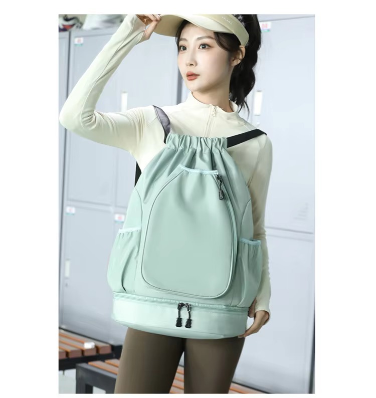 model wearing mint green backpack