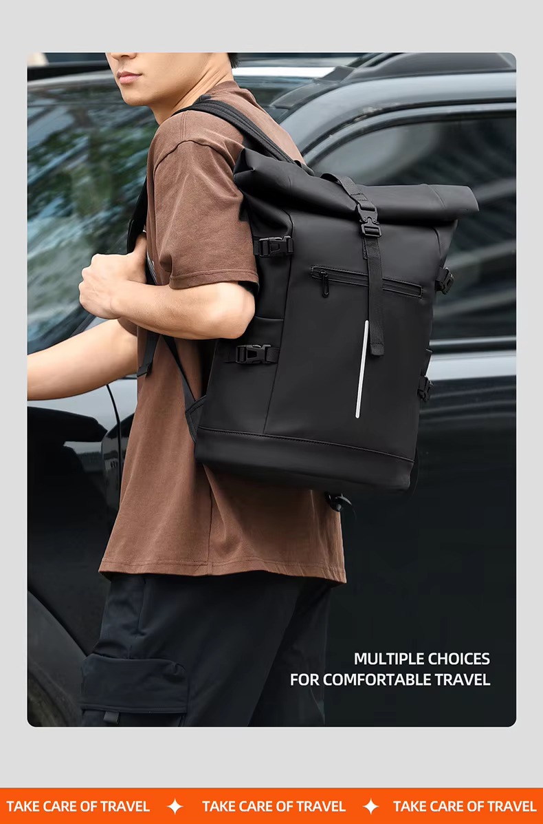 man wearing black roll top backpack
