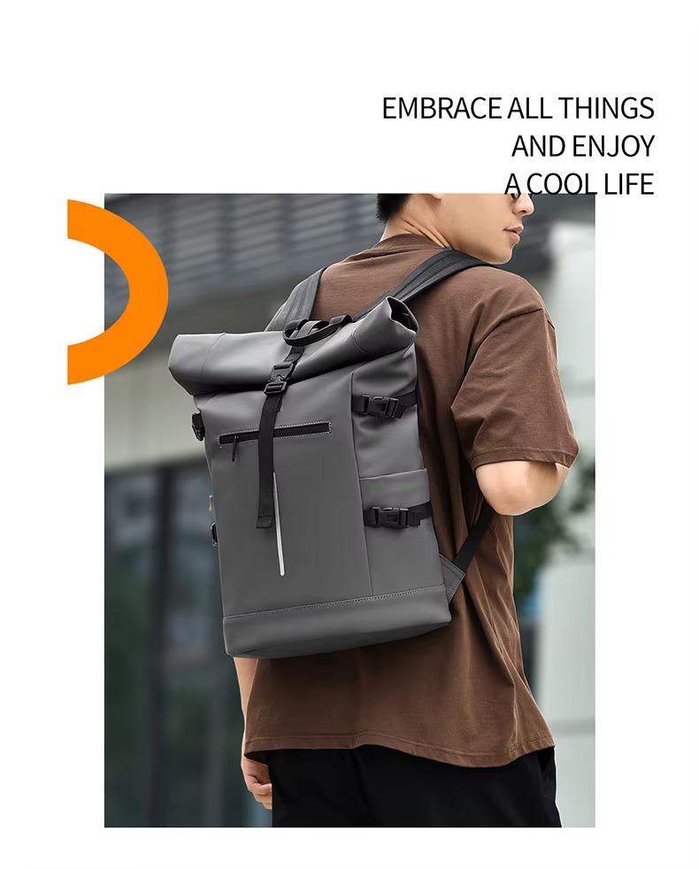 man wearing gray roll top backpack