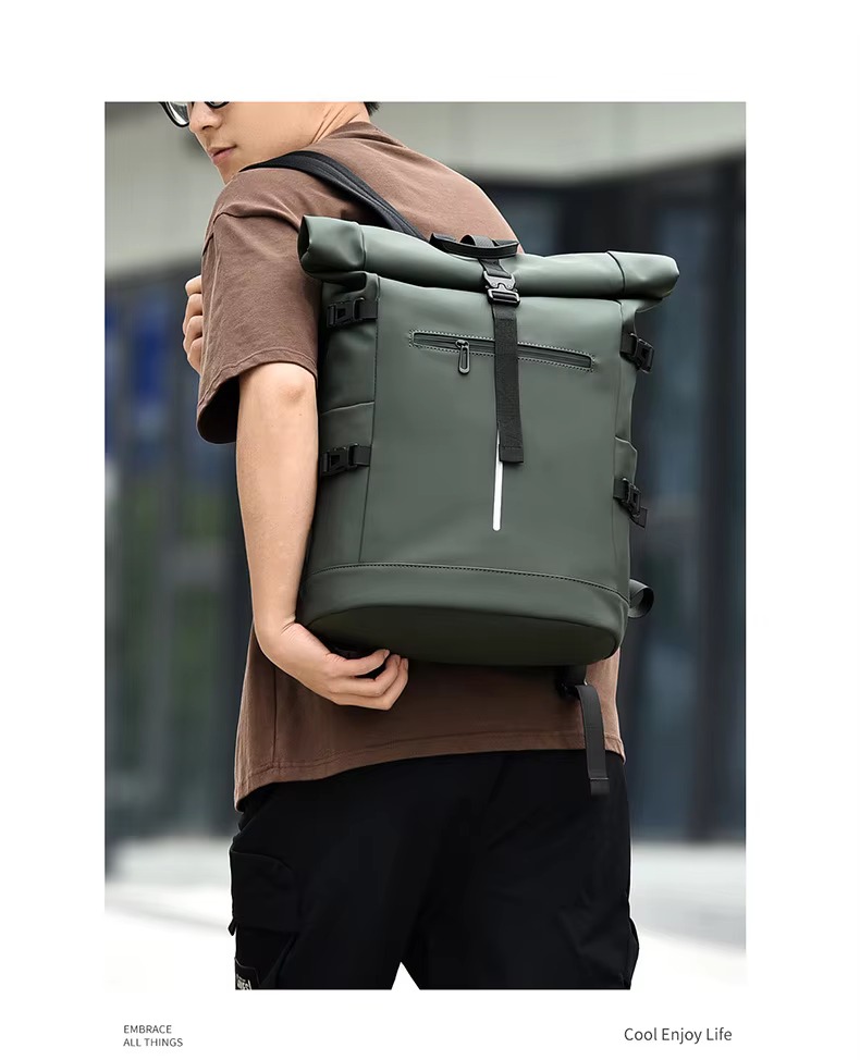 man wearing green roll top backpack