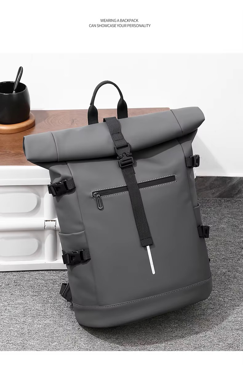 gray roll top backpack on table