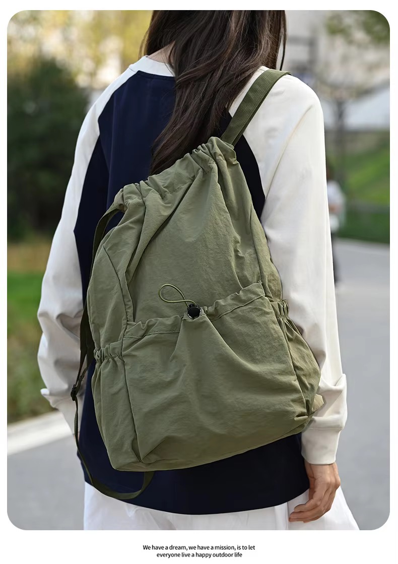 woman wearing green backpack back view