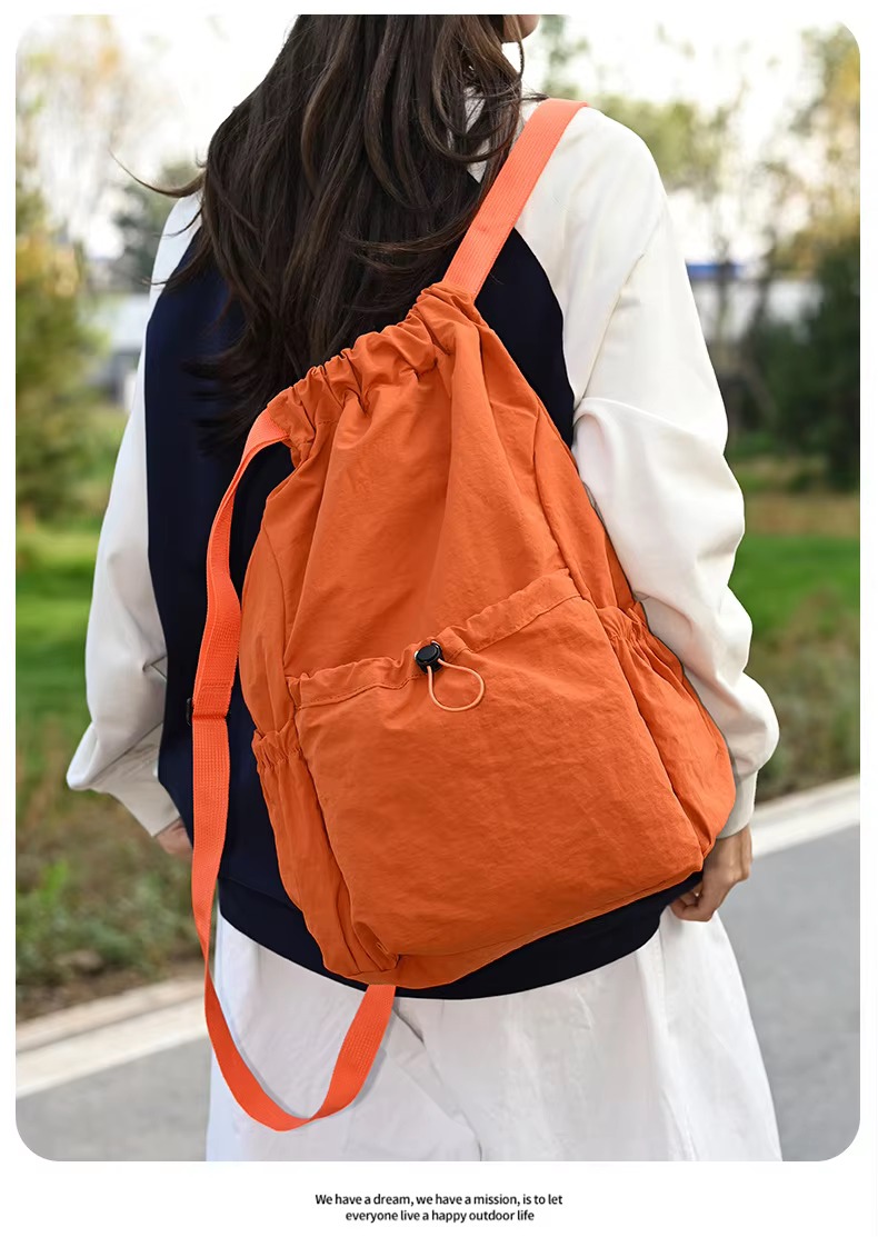 woman wearing orange backpack