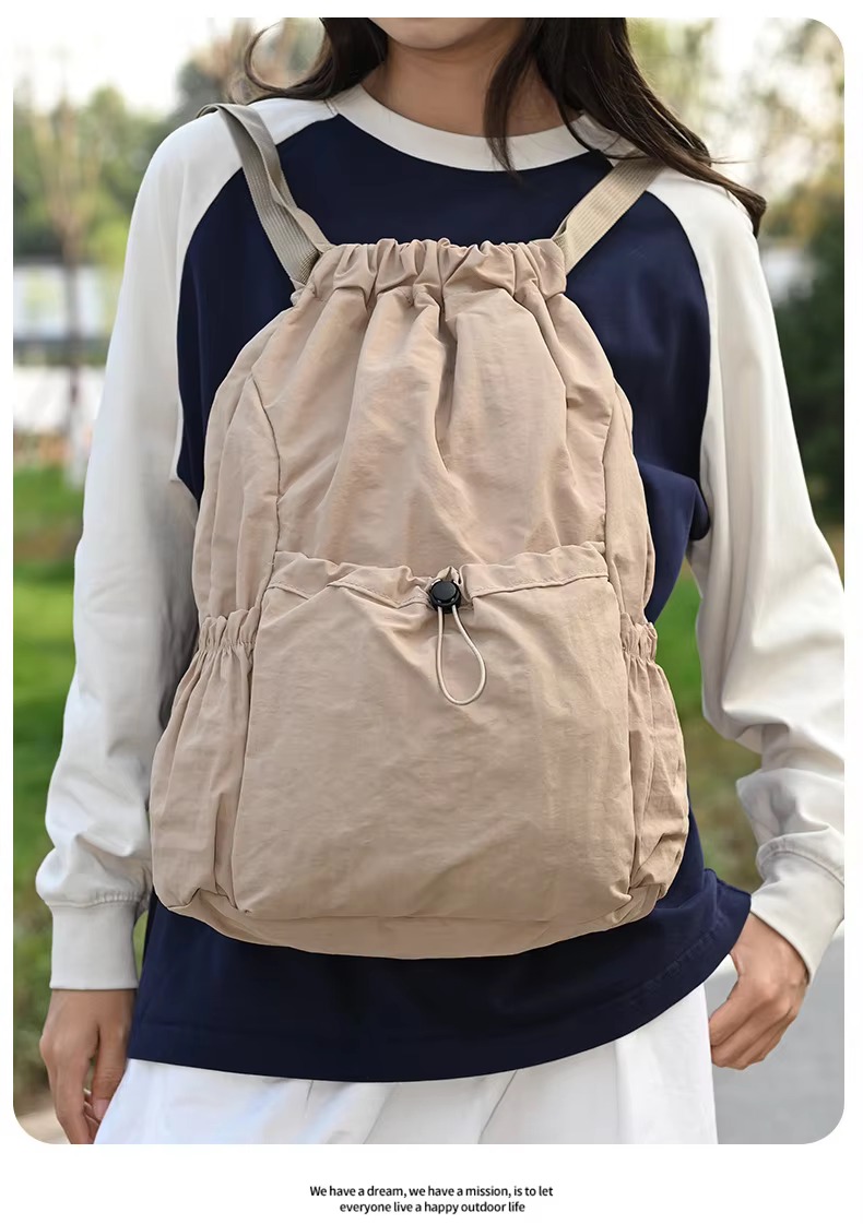 woman wearing beige backpack front