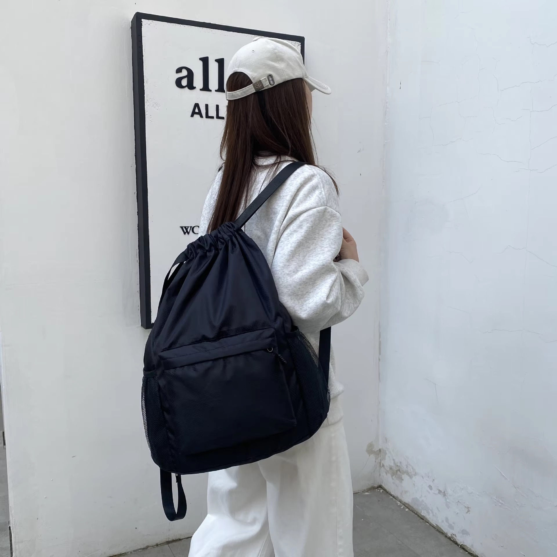 woman wearing black backpack side view