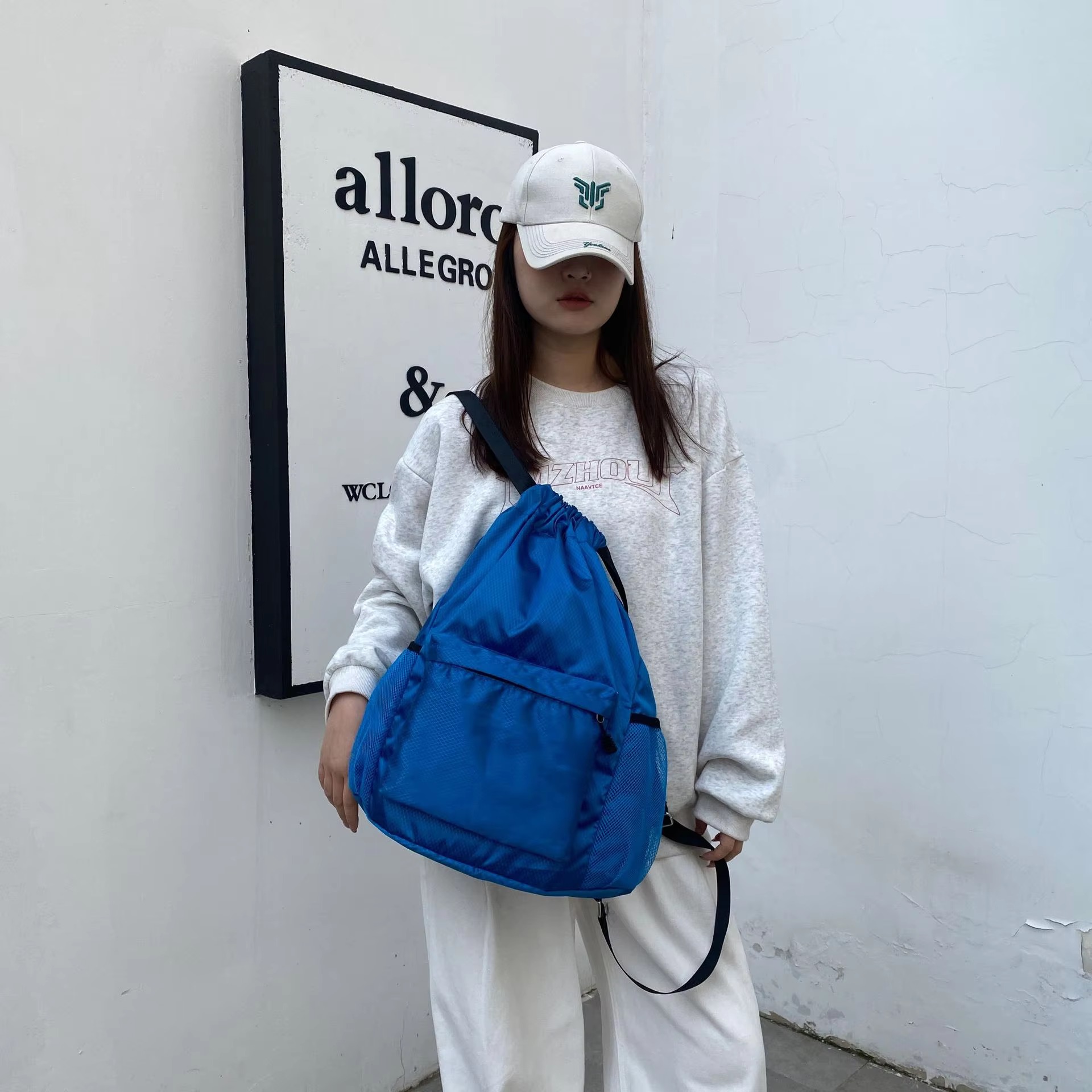 woman carrying royal blue backpack front