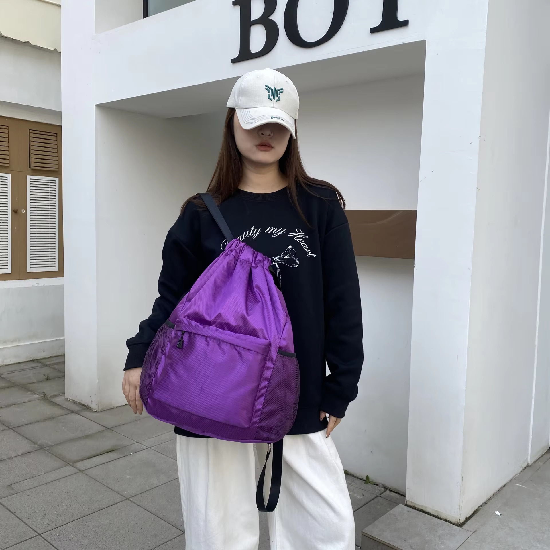 woman wearing purple backpack front