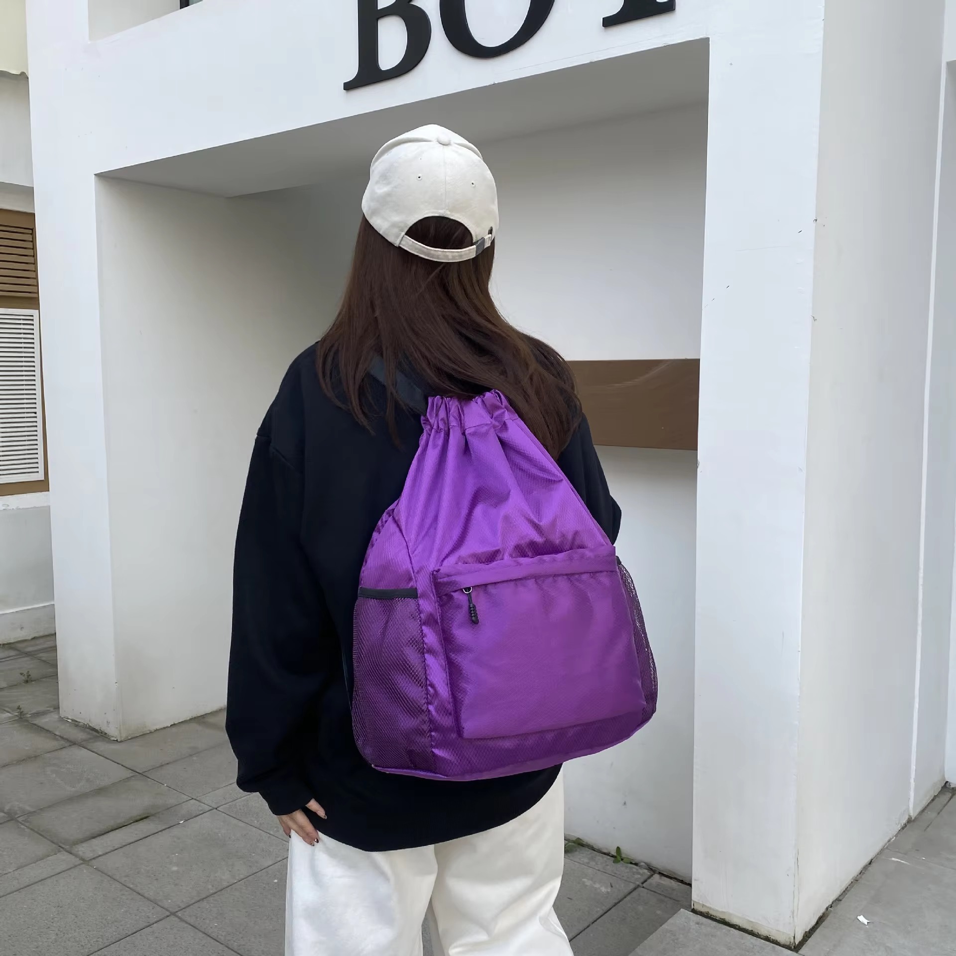woman wearing purple backpack back