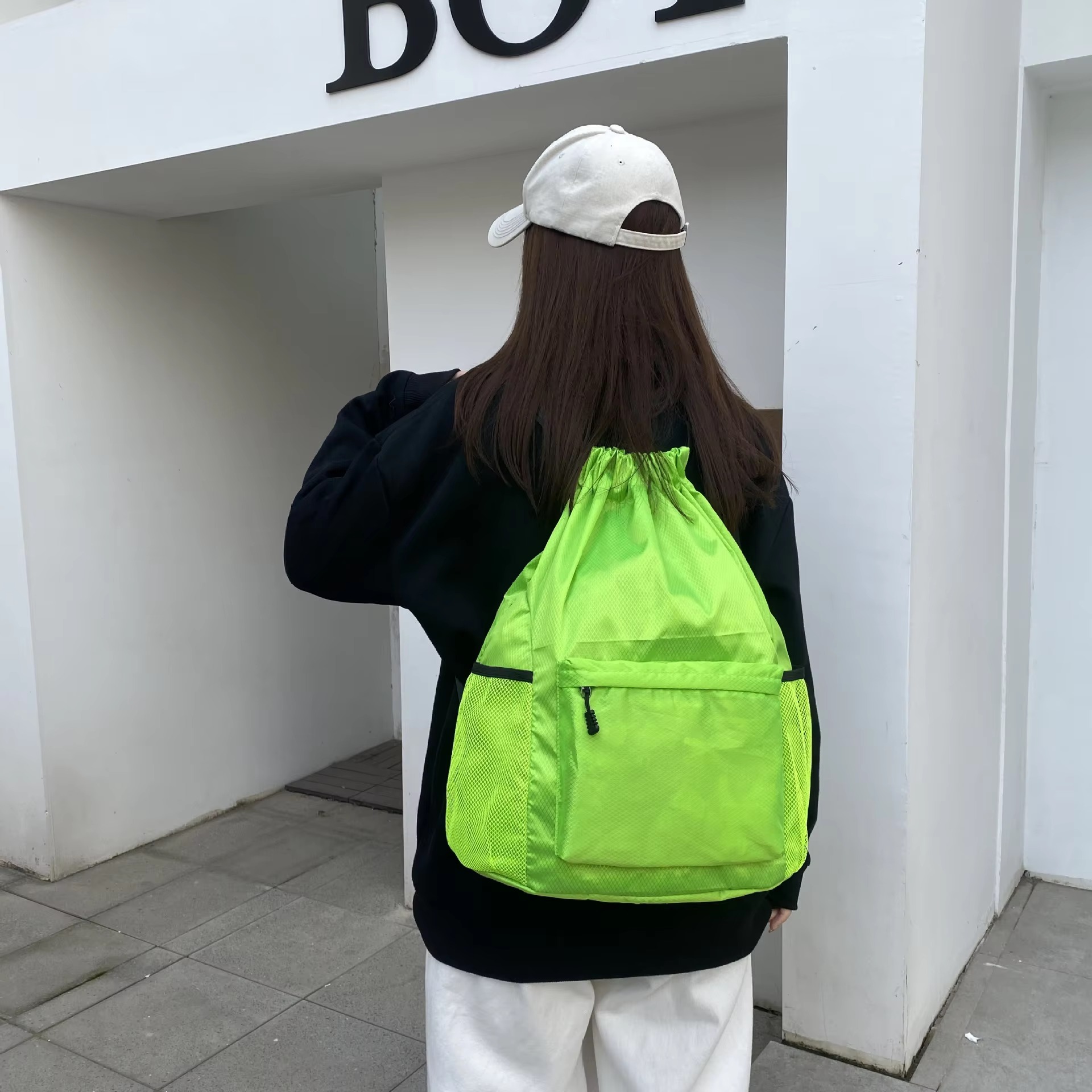 woman wearing fluorescent green backpack