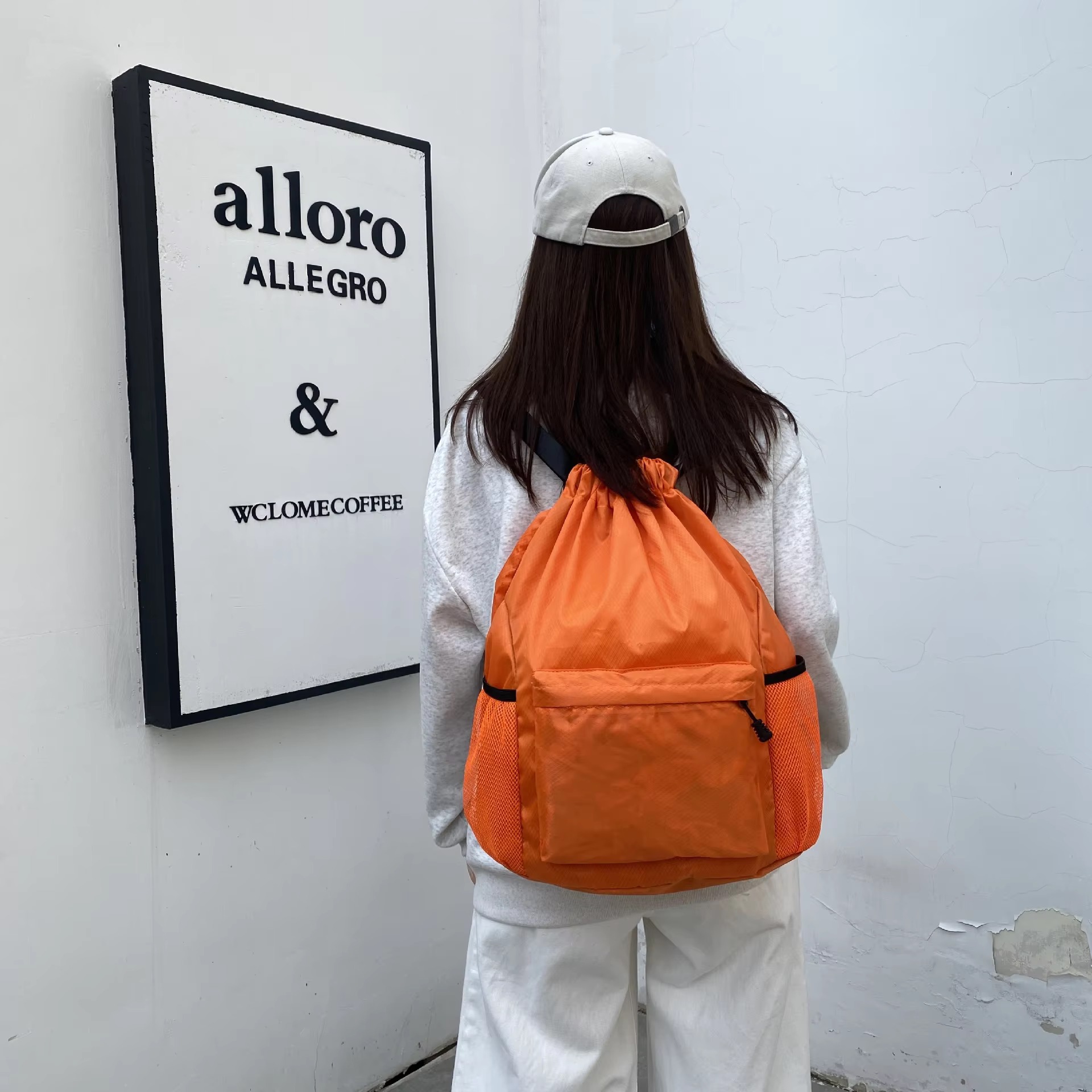 woman wearing orange backpack